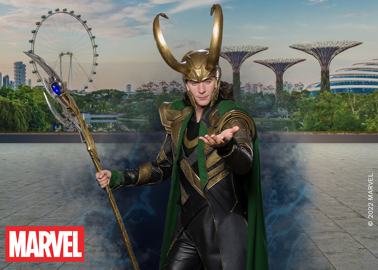 Madame Tussauds Singapore's wax figure of Loki from the Marvel Cinematic Universe, portrayed by actor Tom Hiddleston, wearing his signature green and gold costume and standing confidently with a mischievous expression