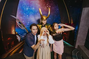  Three Madame Tussauds Singapore visitors are taking fun pictures with a wax figure of Loki from Marvel, indicating that they purchased their tickets at a lower price with fantastic discount promos, ensuring a rewarding and enjoyable experience.