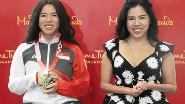 Yip Pin Xiu striking a pose beside her wax twin