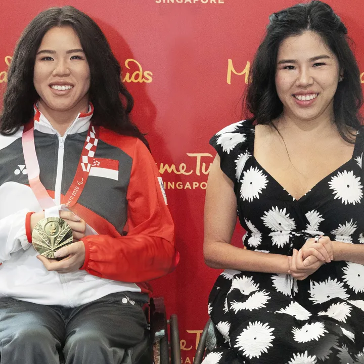 Yip Pin Xiu striking a pose beside her wax twin