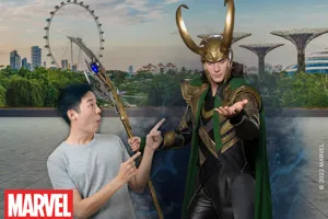 Madame Tussauds Singapore's wax figure of Loki from the Marvel Cinematic Universe, portrayed by actor Tom Hiddleston, wearing his signature green and gold costume and standing confidently with a mischievous expression