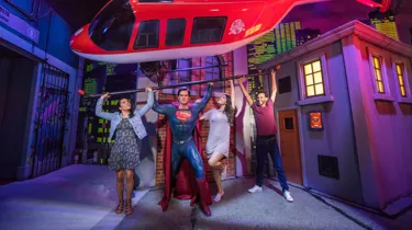 Guests with superman figure lifting helicopter
