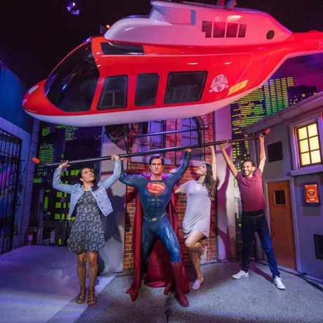 Guests with superman figure lifting helicopter