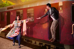 man and woman reaching from a train