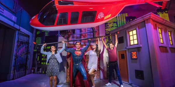 family holding up helicopter with superman