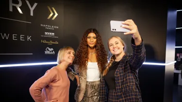 people taking a picture with zendeya wax figure