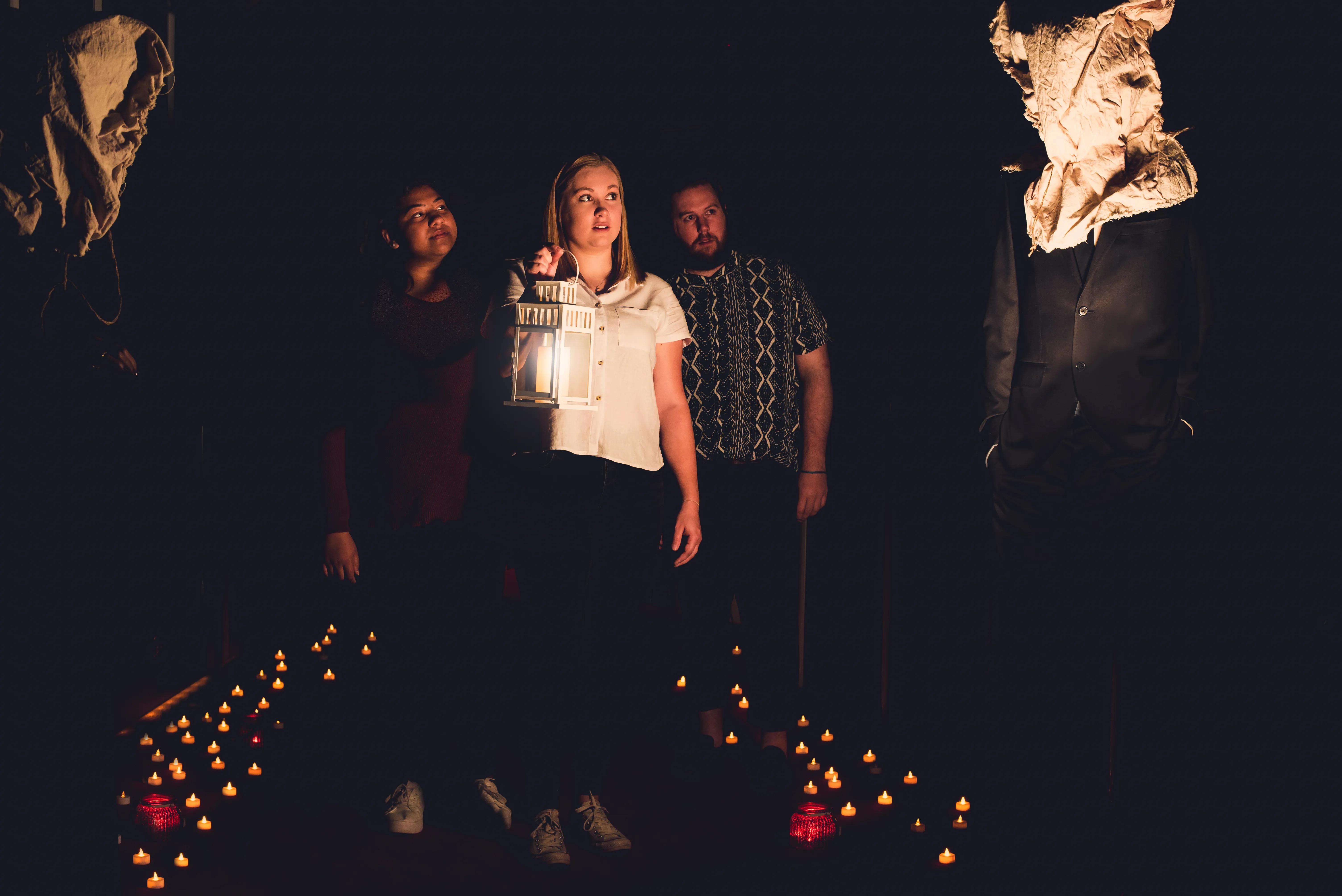 group walking in the dark with lantern