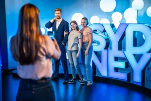 Guests posing with Chris Hemsworth Wax Figure and SYDNEY Sign