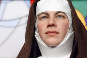mary mackillop wax work in front of stain glass window