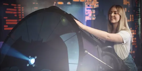 girl holding light with bat symbol