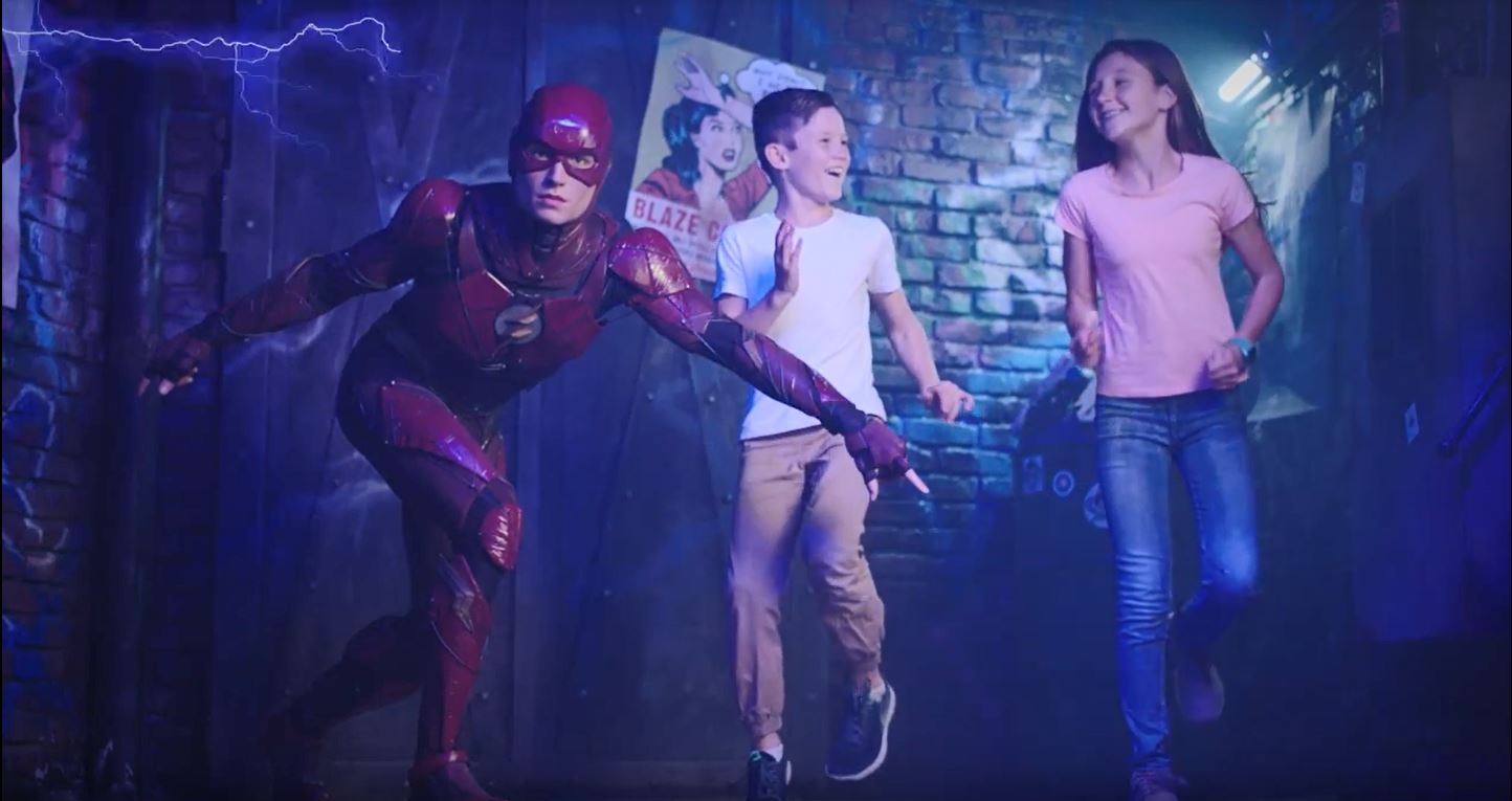 the flash waxwork with 2 children on front of brick wall