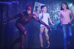 the flash waxwork with 2 children on front of brick wall