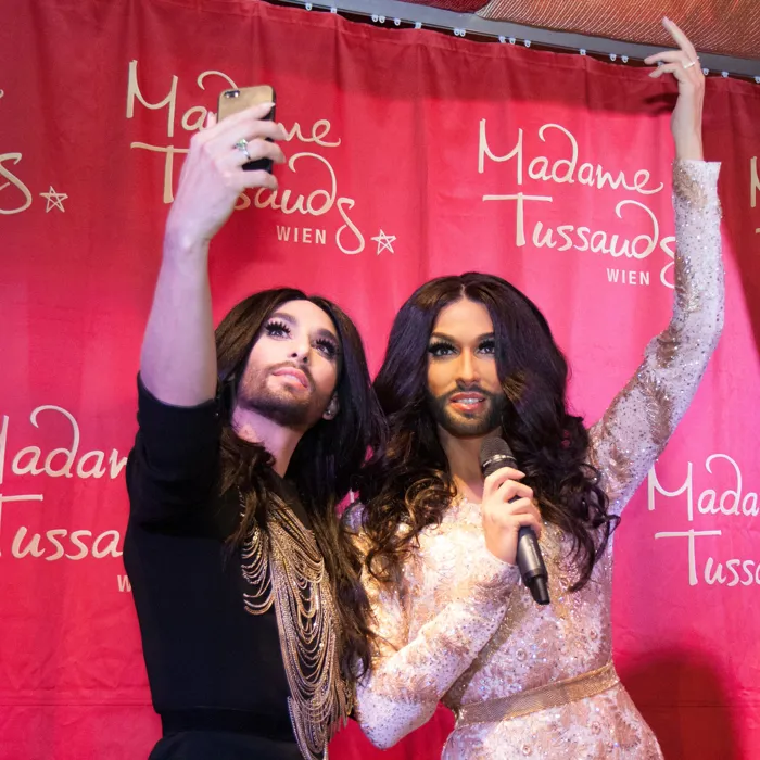 Conchita Wurst takes a selfie with herself.